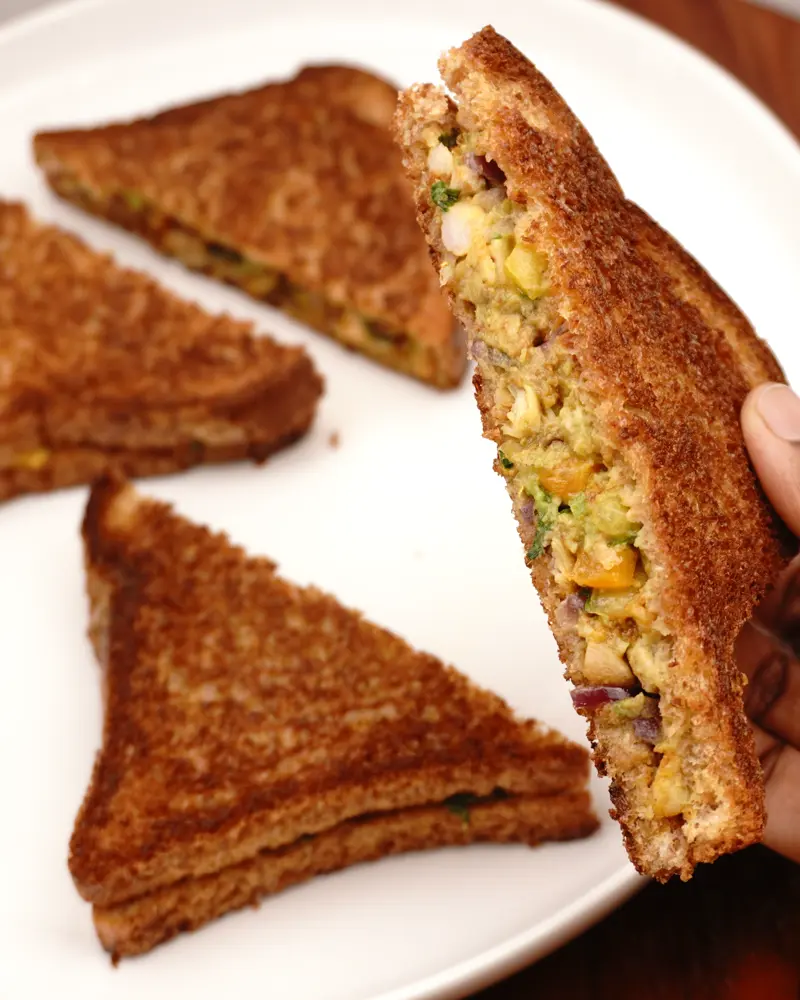 Avocado Chicken Tikka Sandwich - close up view of finished dish plated and garnished