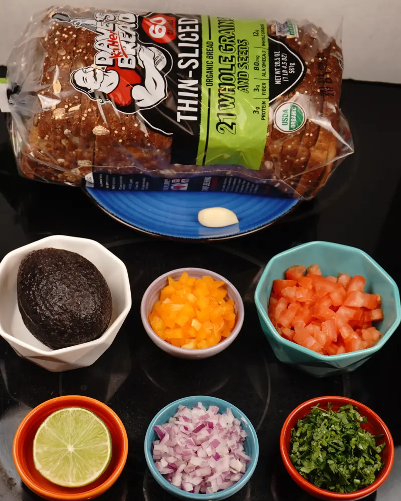 Ingredients for Avocado Veggie Salad Open Sandwich including Whole grain bread, Hash avocado, Finely chopped onion