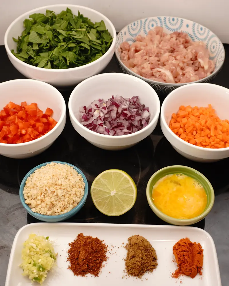 Ingredients for  Veggie Loaded Chicken seekh kebab including Boneless chicken leg(thigh/drumstick) pieces, Carrot, Spinach, coriander and mint leaves