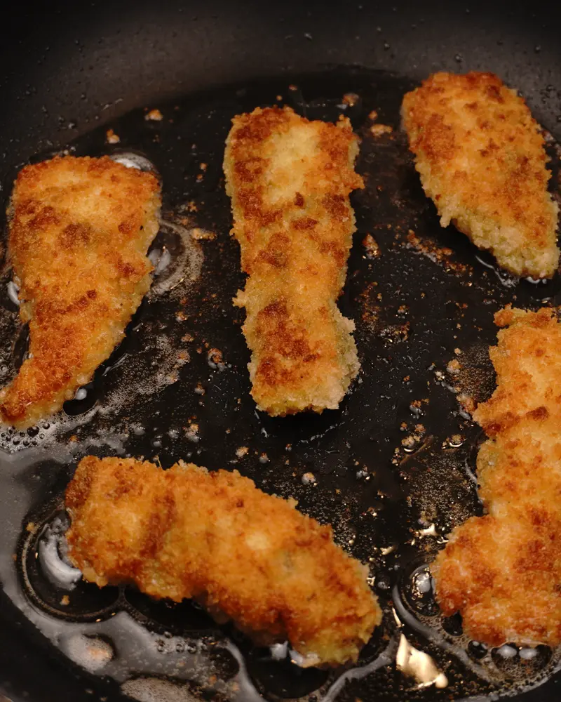 Crispy Pan Fried Panko Chicken - close up view of finished dish plated and garnished