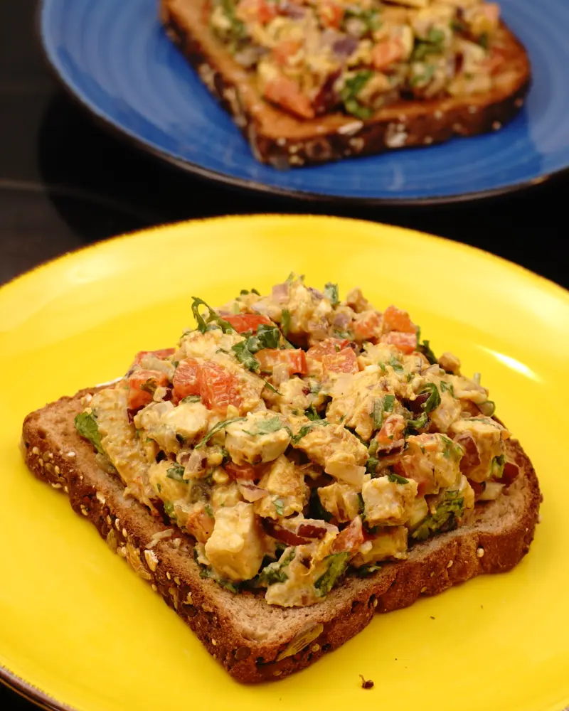 Curd Chicken Open Sandwich - close up view of finished dish plated and garnished
