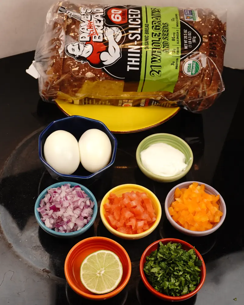 Ingredients for Curd Egg Veggie Salad Open Sandwich including Whole grain bread, Hard boiled egg, Low fat/ fat free Hung curd(yogurt)