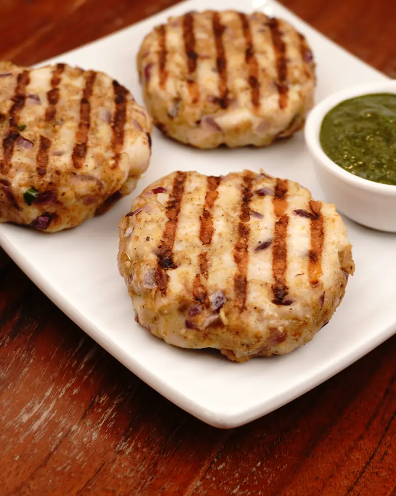 Low Calorie Pan Grilled Chicken Patty Kebab - close up view of finished dish plated and garnished