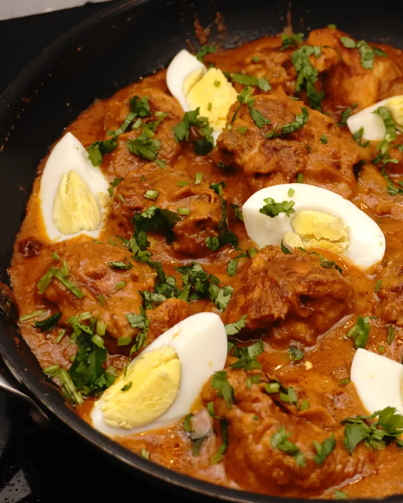 Mughlai Chicken Curry - close up view of finished dish plated and garnished