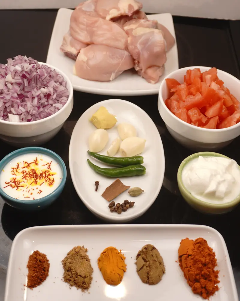 Ingredients for Mughlai Chicken Curry including Bone In Chicken, Onions, Tomatoes