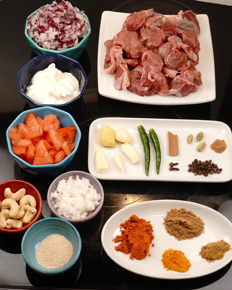 Ingredients for Pot-Cooked Mutton Curry (Baby Goat) — Restaurant Style including Baby goat bone in pieces, Finely chopped onion, Tomato