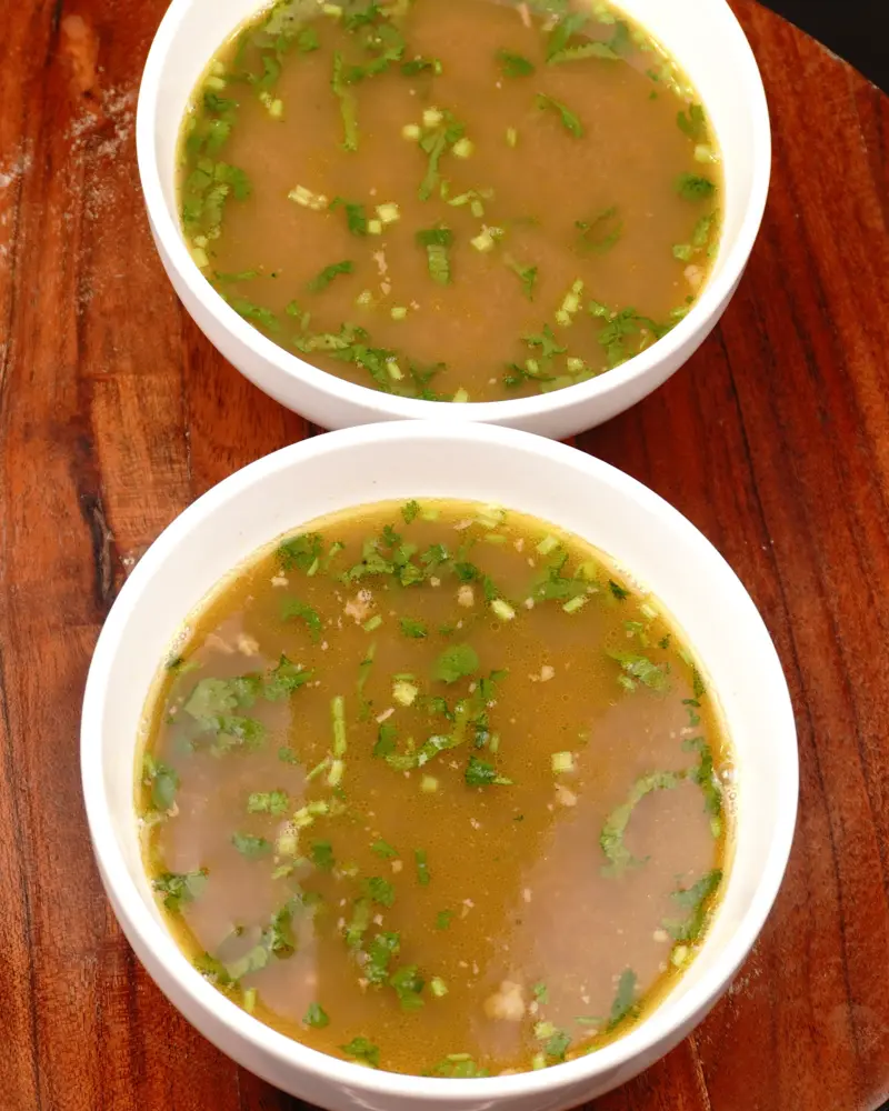 Baby Goat Mutton Shorba (Soup) - close up view of finished dish plated and garnished