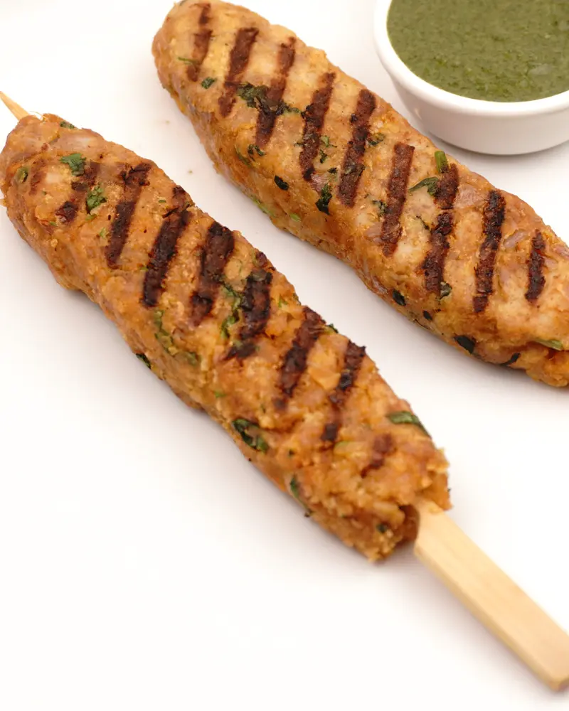 Perfect Pan-Grilled Chicken Seekh Kebab – Restaurant Style at Home - close up view of finished dish plated and garnished
