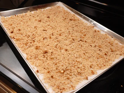 Bread Crumbs - Cover the large baking tray with sheet of parchment paper and spread the prepared fresh bread crumbs on paper