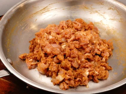 Transfer the coarse mixture from work bowl to the pan. Then repeat the above step for remaining marinated chicken pieces and masala mixture. 