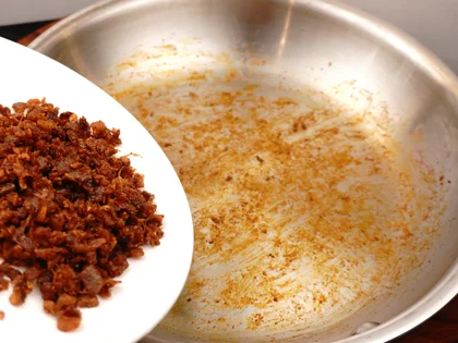 After the pan cool down, transfer the masala mixture from pan to plate, place the prepared chicken pieces in pan   