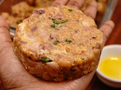 Apply oil on your hands, take one portion of chicken mixture to form a loosely packed ball then lightly flatten the ball at the top to form circular shape chicken patty 