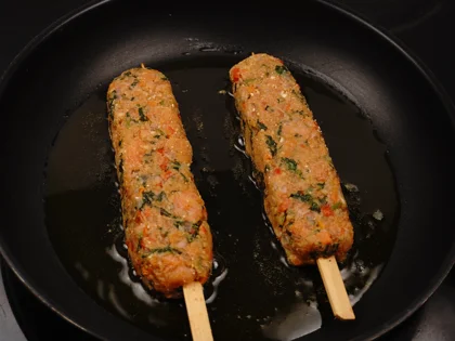 Veggie Loaded Fish Seekh Kebab - Cook the skewers first side untill form brown/dark brown crust over medium flame