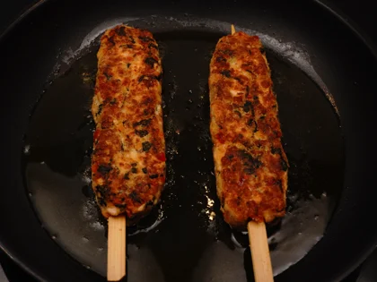 Flip the fish skewers on second side, reduce the heat to medium-low, until form brown/dark brown crust