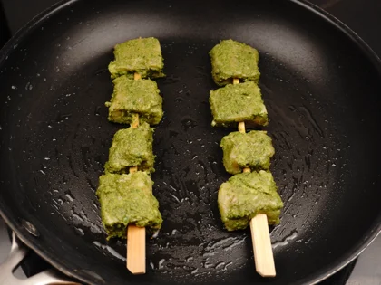 Place the chicken skewers on hot pan and contiue to cook them without moving, until to attain golden color underside the skewers 