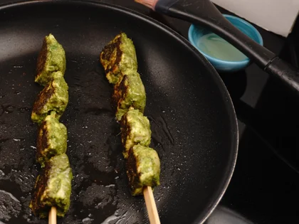 Low Carb, Less Oil Hariyali Tikka  - Cook on both thin sides of the skewers on medium flame then flip flat side