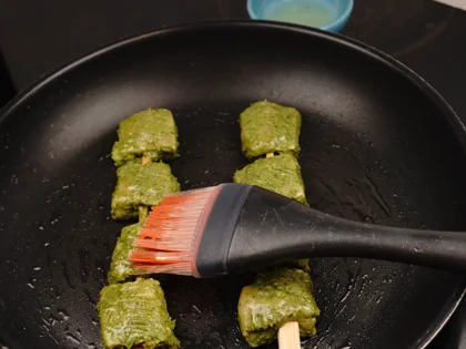 Place the chicken skewers on hot pan and contiue to cook them without moving, until to attain golden color underside the skewers 