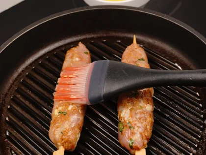 Just before flip them, baste ghee on top side of the chicken skewers then flip them & reduce the heat to low  