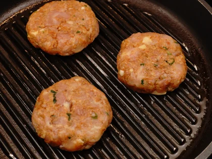 Place the oiled surface chicken patties on the hot grill pan and continue to cook them without moving, untill to attain dark brown grill marks underside the chicken skewers for about 4 to 5 minutes over medium flame 