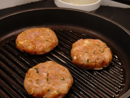 Place the oiled surface chicken patties on the hot grill pan and continue to cook them without moving, untill to attain dark brown grill marks underside the chicken skewers for about 4 to 5 minutes over medium flame 