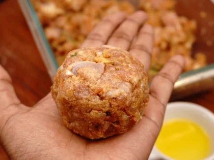 Apply oil on your hands, take one portion of chicken mixture to form a loosely packed ball then lightly flatten the ball at the top to form circular shape chicken patty 