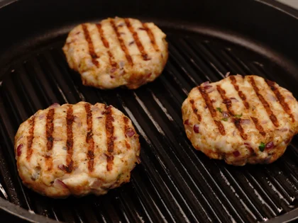 Just before flip them, baste oil on top side of the chicken patties then flip them & reduce the heat to low  