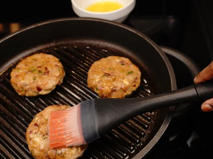 Just before flip them, baste oil on top side of the chicken patties then flip them & reduce the heat to low  