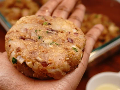 Apply oil on your hands, take one portion of chicken mixture to form a loosely packed ball then lightly flatten the ball at the top to form circular shape chicken patty 