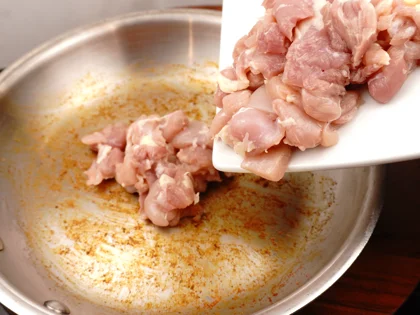 After the pan cool down, transfer the masala mixture from pan to plate, place the prepared chicken pieces in pan   